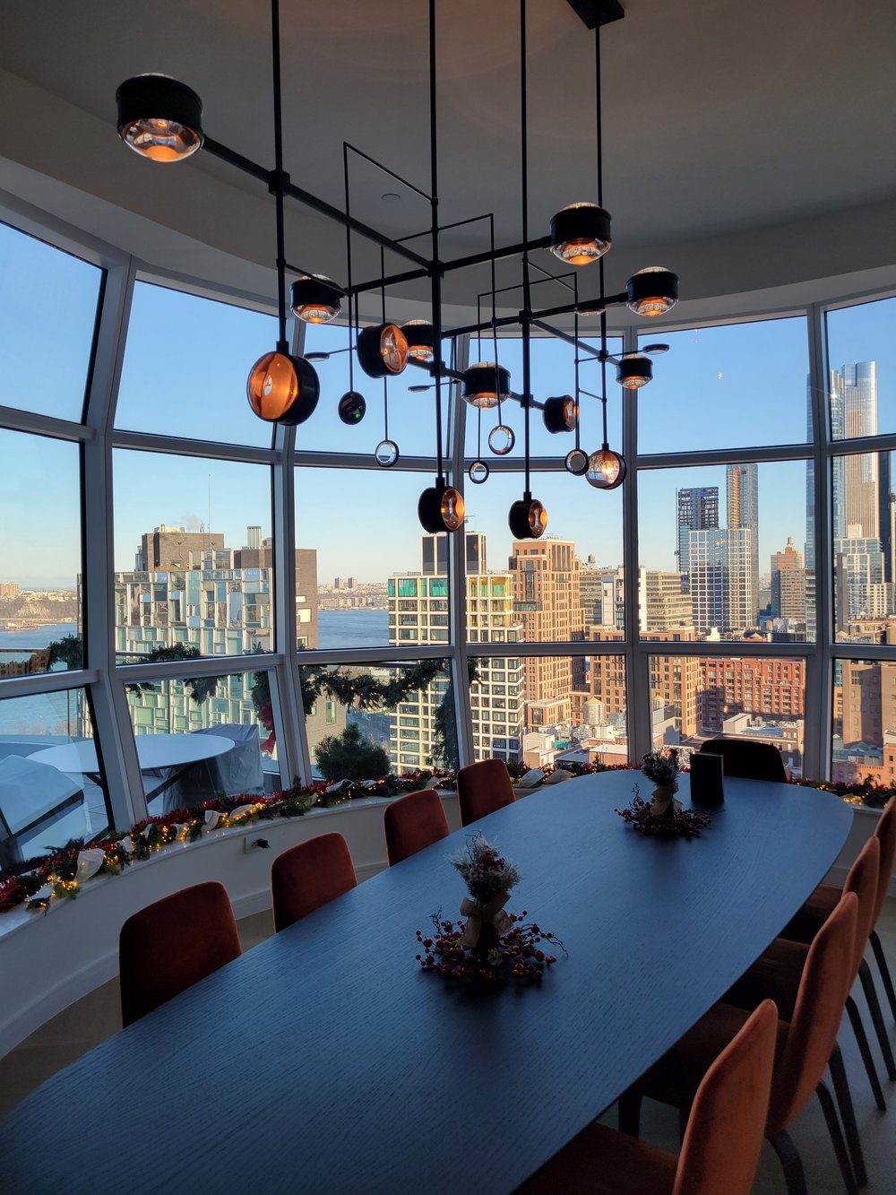 Executive high-rise conference room with dramatic floor-to-ceiling glass walls offering panoramic views of