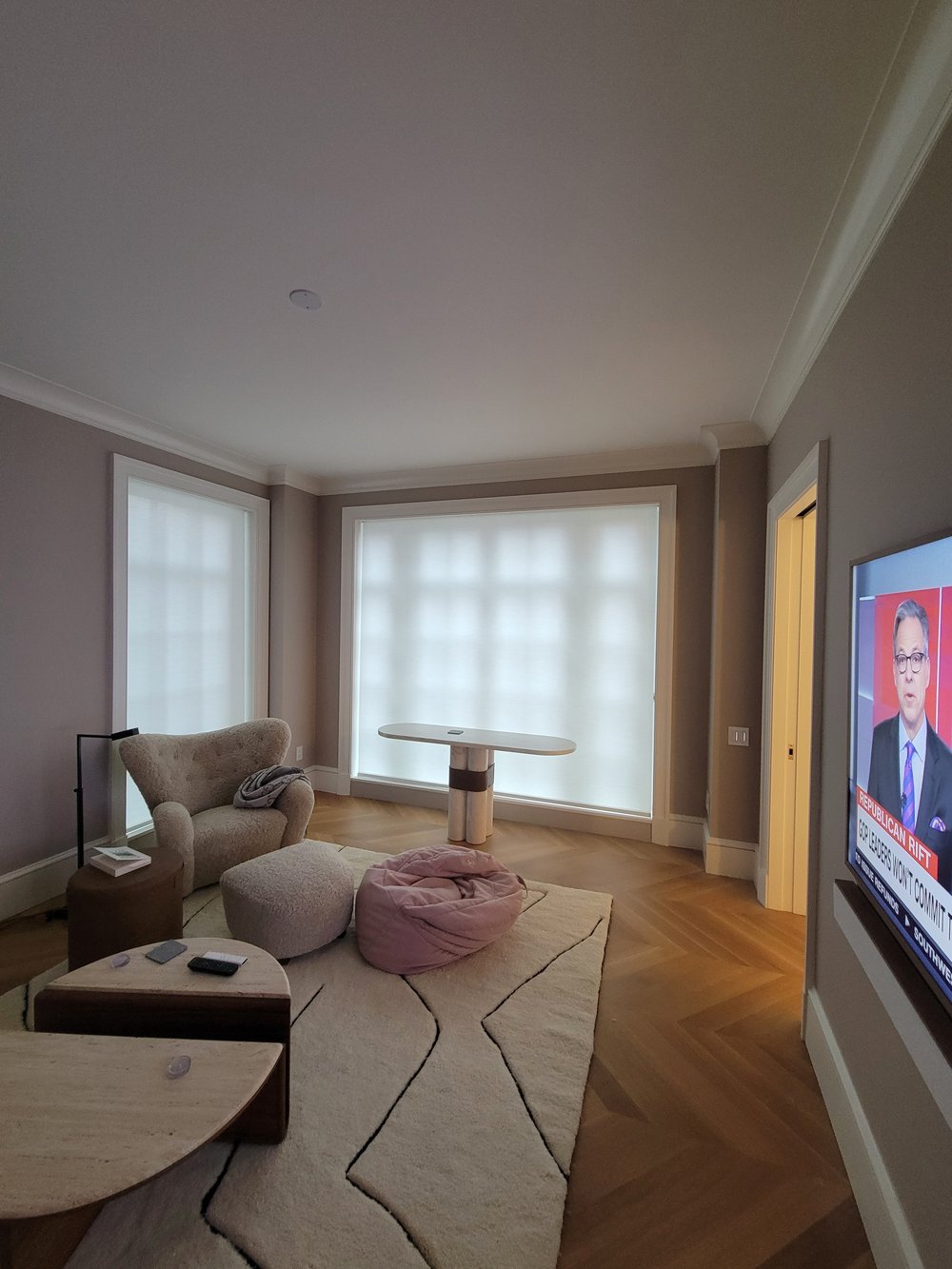 Finished modern living room emphasizing control and comfort in a media-equipped space. A sculptural designer