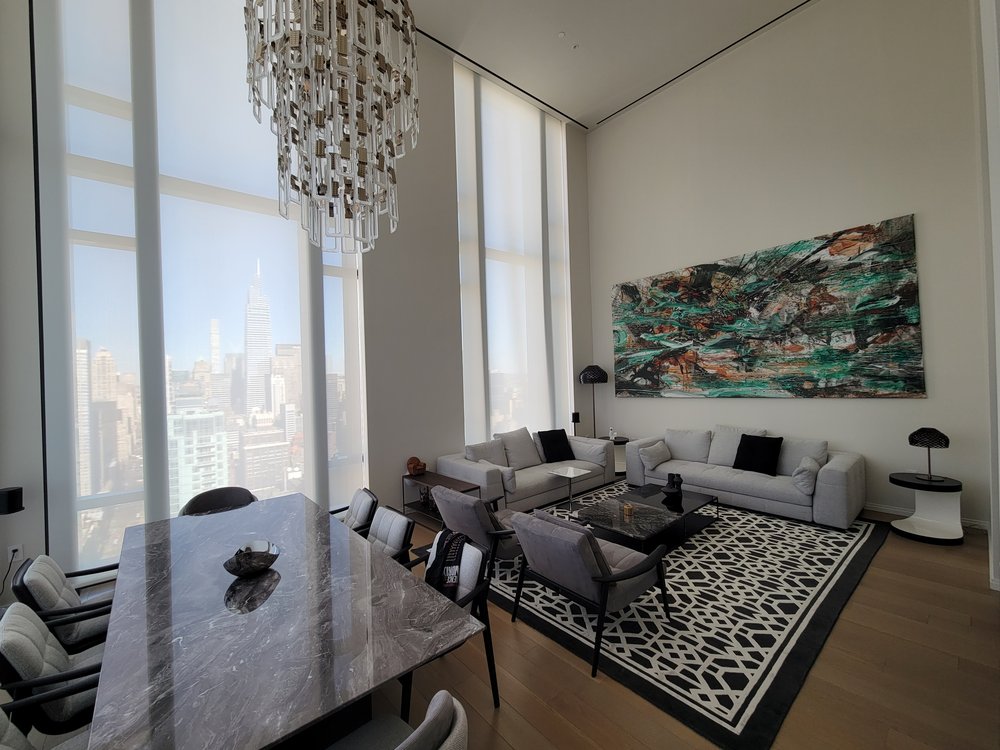 Sophisticated high-end living and dining space in a luxury high-rise apartment with spectacular