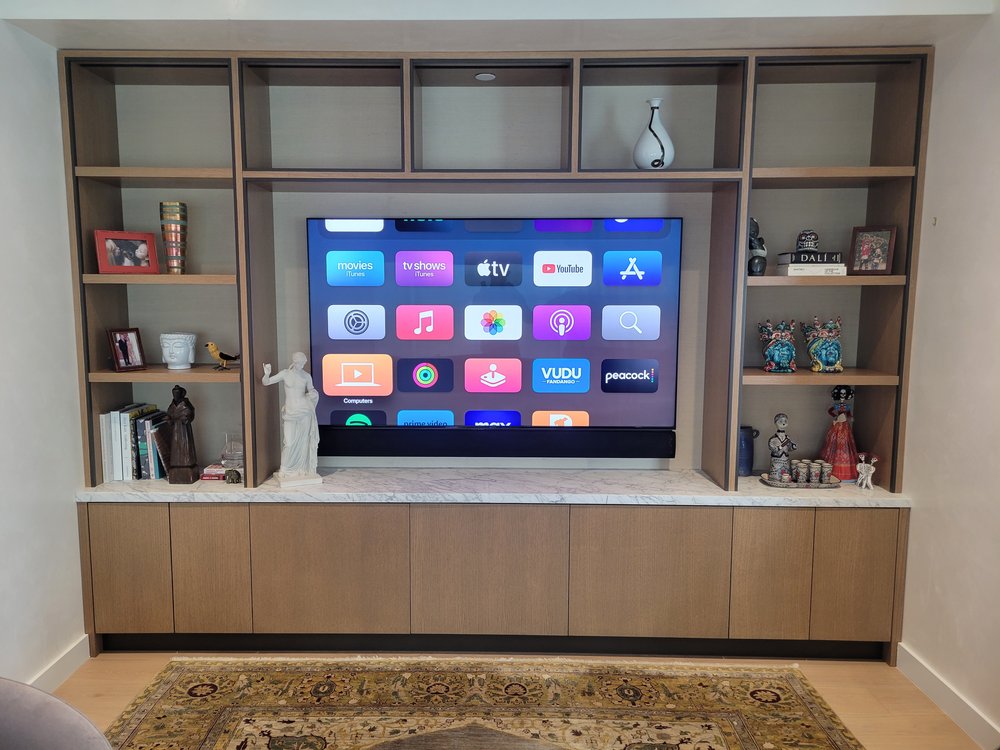 A professionally designed media room with dedicated audio-visual systems and optimized lighting control. Dark