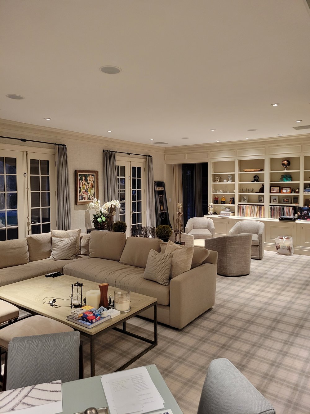 A grand living room combining residential comfort with sophisticated design. The space features extensive