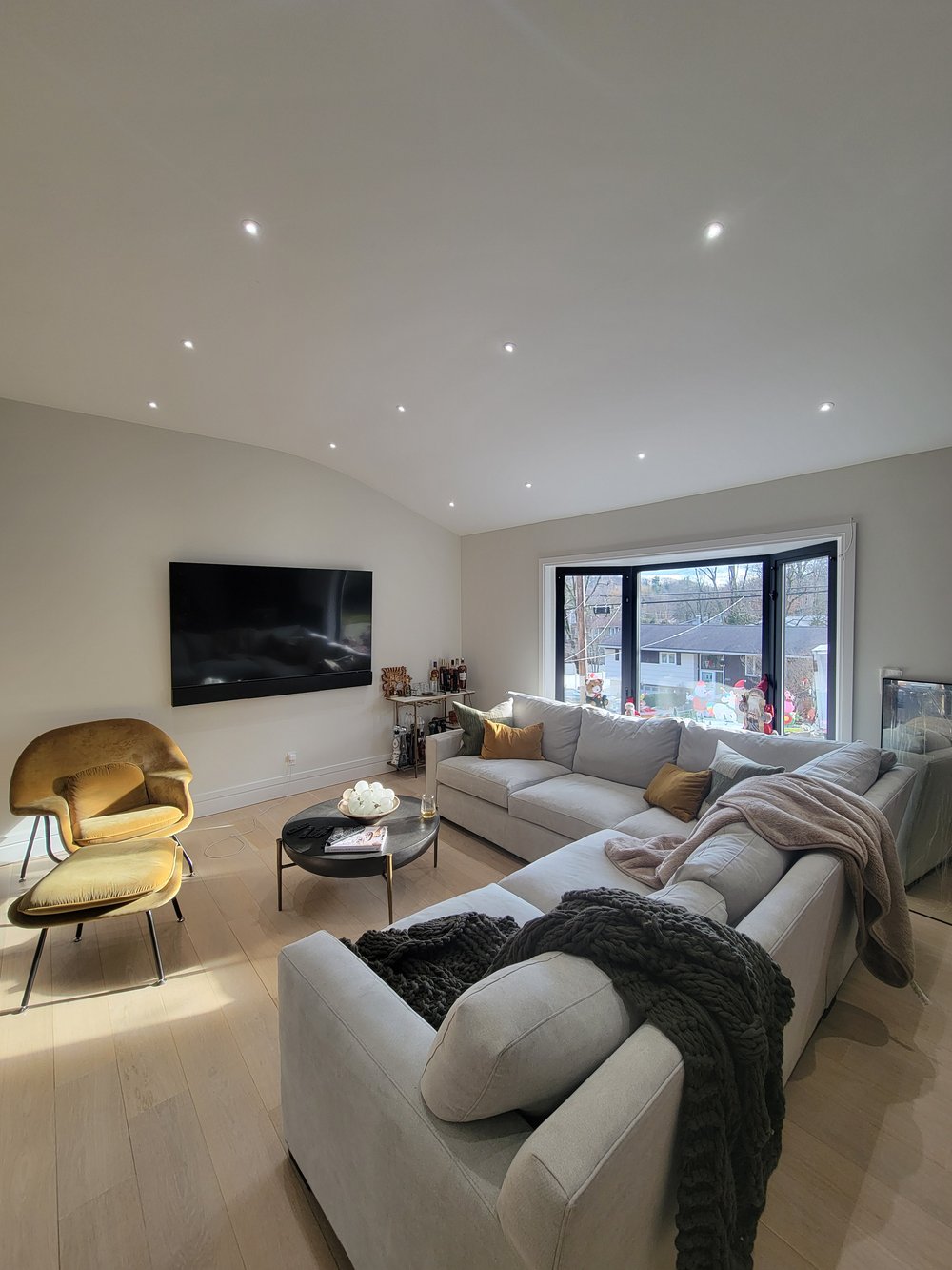 Sophisticated living room with suspended drywall ceiling featuring distributed recessed LED lighting array