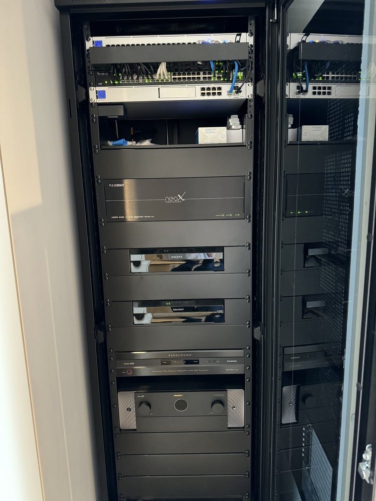 Professional equipment rack installation photographed from the front. Multiple custom-built modules mounted