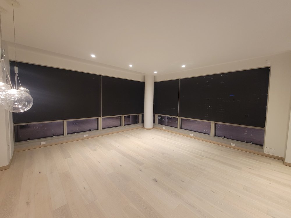 Modern residential living room featuring a wall-mounted flat-screen TV displaying a serene landscape image,