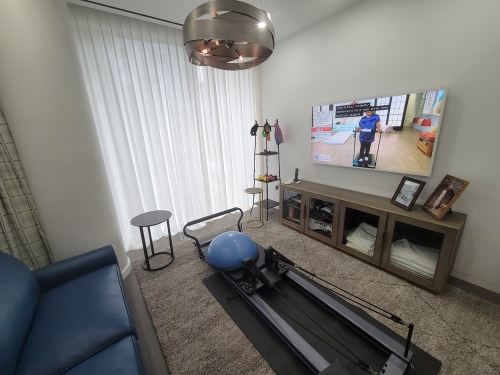 Second angle of the same finished media and fitness room as ID 183. The photograph documents the