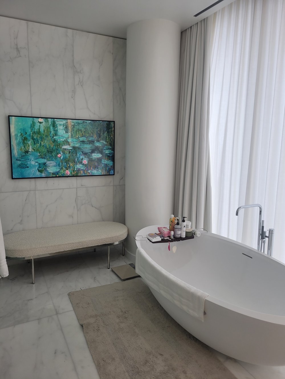 Closely matching angle of the luxury master bathroom suite with white sculptural freestanding tub as