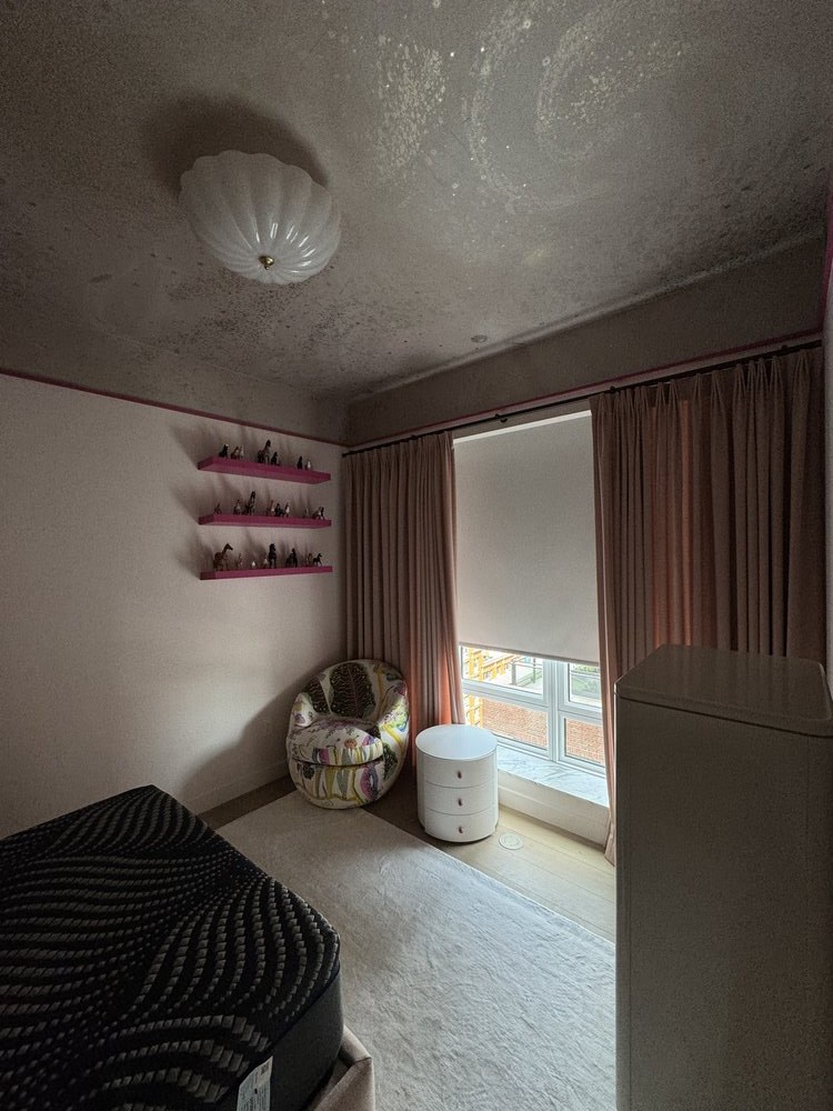 Bedroom photographed from overhead angle showing recessed LED lighting panels in the ceiling arranged in a
