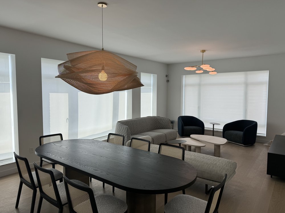A well-appointed media room with finished interior design and integrated smart home technology. The space