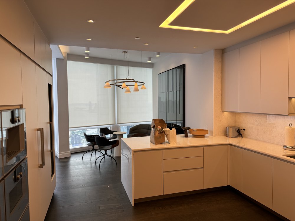 A professionally finished home theater space showcasing high-end audio/visual installation. The room features