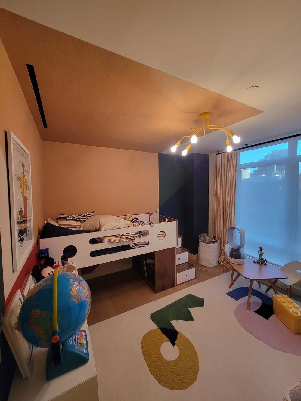 Imaginative children's bedroom with bold architectural ceiling feature in warm orange and tan tones creating