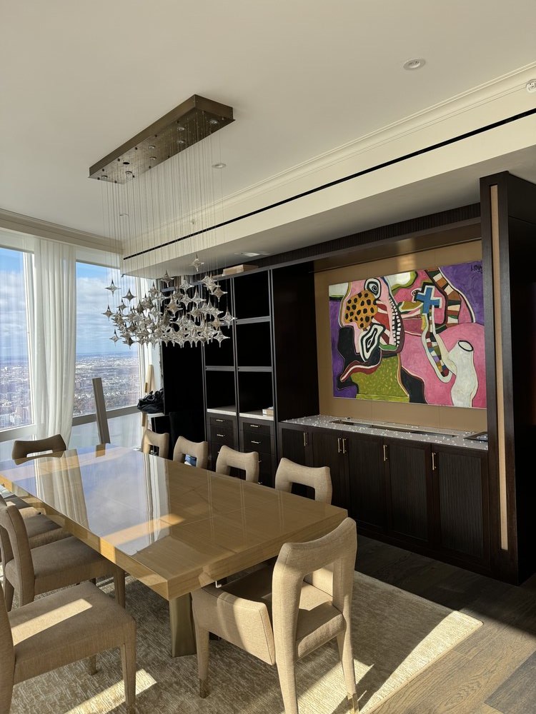 Luxurious modern living and dining space in a high-rise with stunning panoramic NYC skyline views through