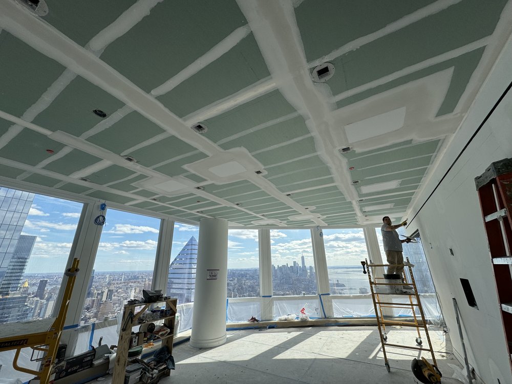 Large high-rise space under construction with dramatic floor-to-ceiling windows showcasing panoramic