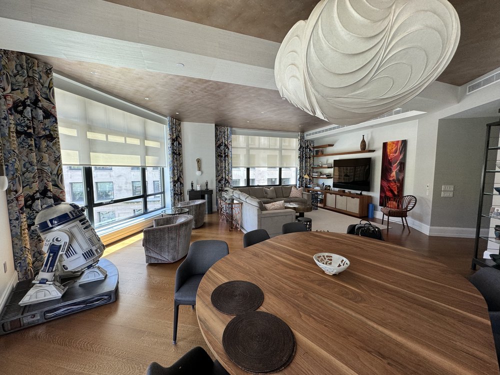 Ultra-luxurious high-rise showroom or model penthouse featuring dramatic sculptural ceiling element,