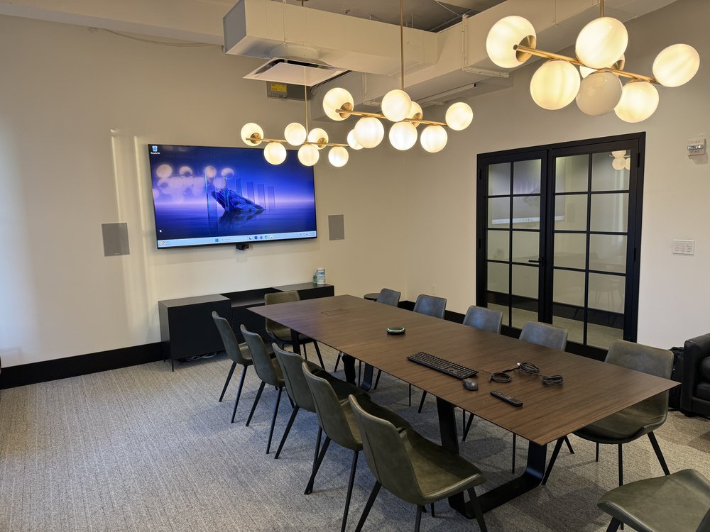 High-rise residential workspace with integrated desk setup featuring wood-grain paneling and wall-mounted