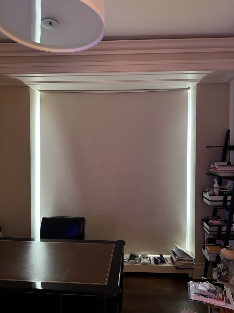 Modern bathroom vanity installation featuring a large illuminated mirror with integrated LED edge lighting