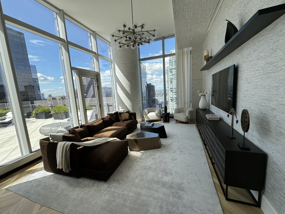 Stunning high-rise living room and terrace showcasing panoramic Manhattan skyline views through