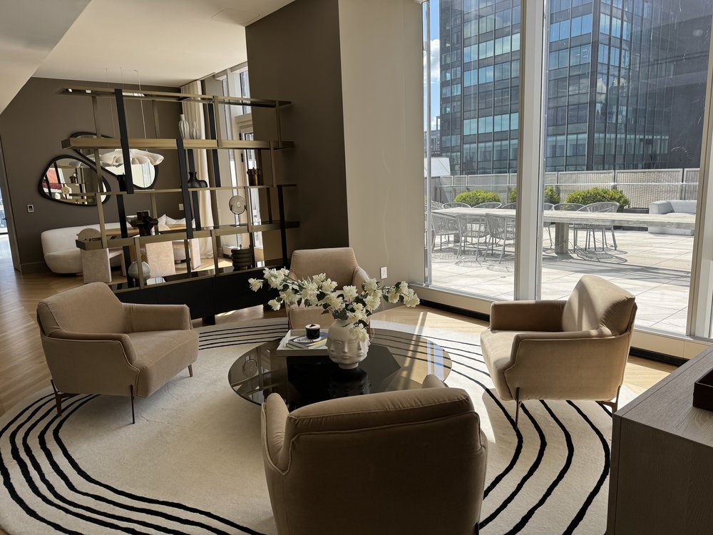 Modern high-rise penthouse with expansive open-plan layout combining dining and living zones. The space